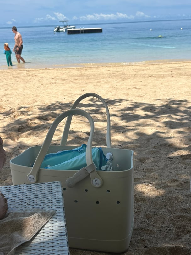 Croc tote bag on beach.