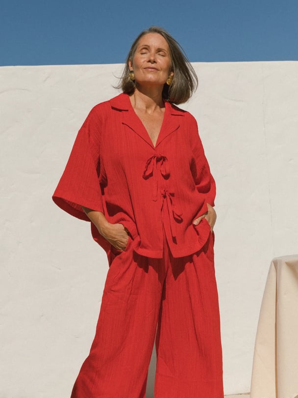 Model in oversized tie-up red shirt.