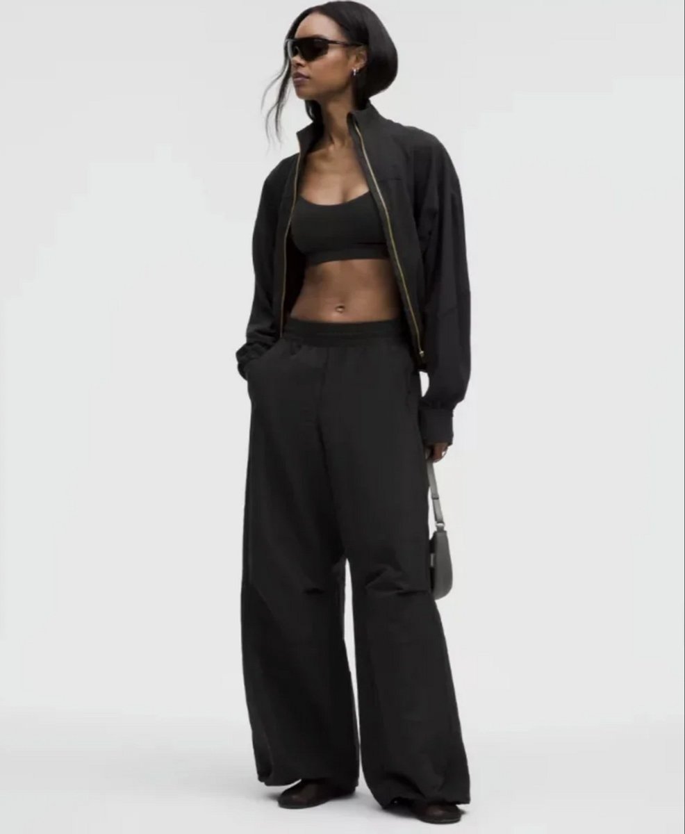 woman wearing black parachute pants form lululemon 