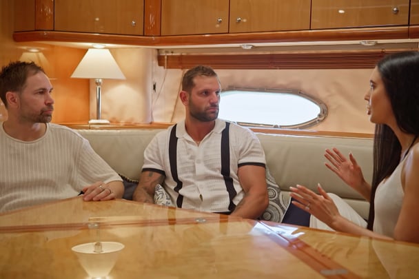 Scott chats with two of his friends on the boat.