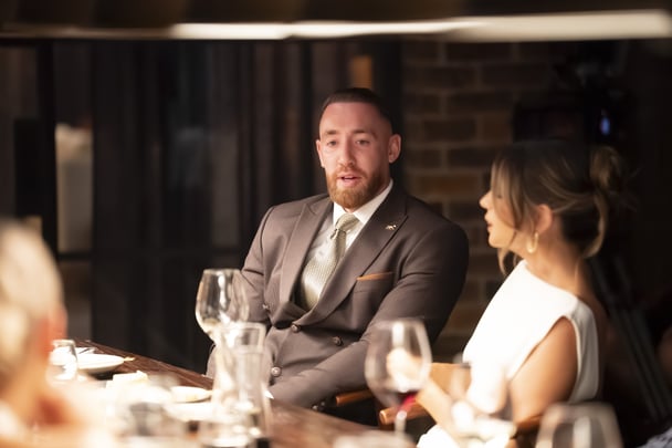 Danny and Bec chat at the dinner table.