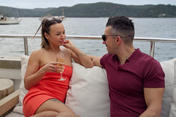 Stella and Filip chat on a boat.