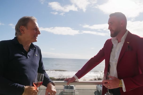 Danny chats to Bec's dad on the balcony.