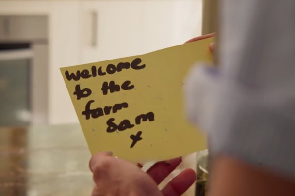 A yellow card reading 'welcome to the farm Sam x'.