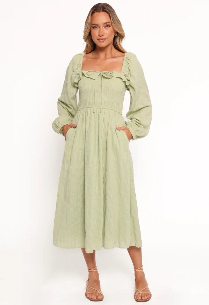 woman wearing a midi dress in green