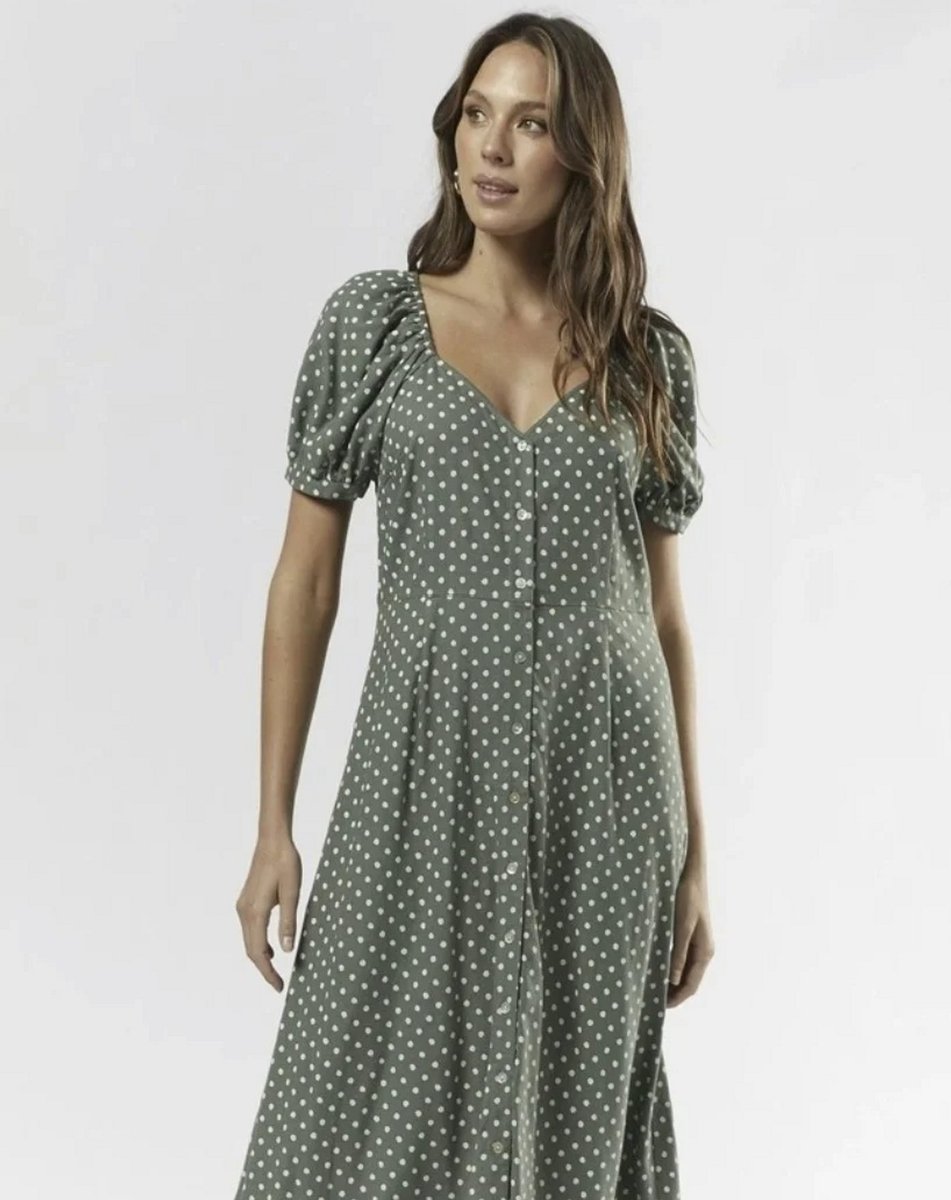 woman wearing polka dot sage green dress