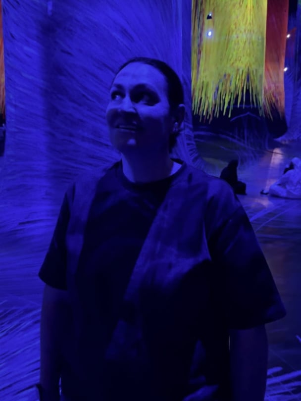 Nat in teamLabs in a blue lit room.