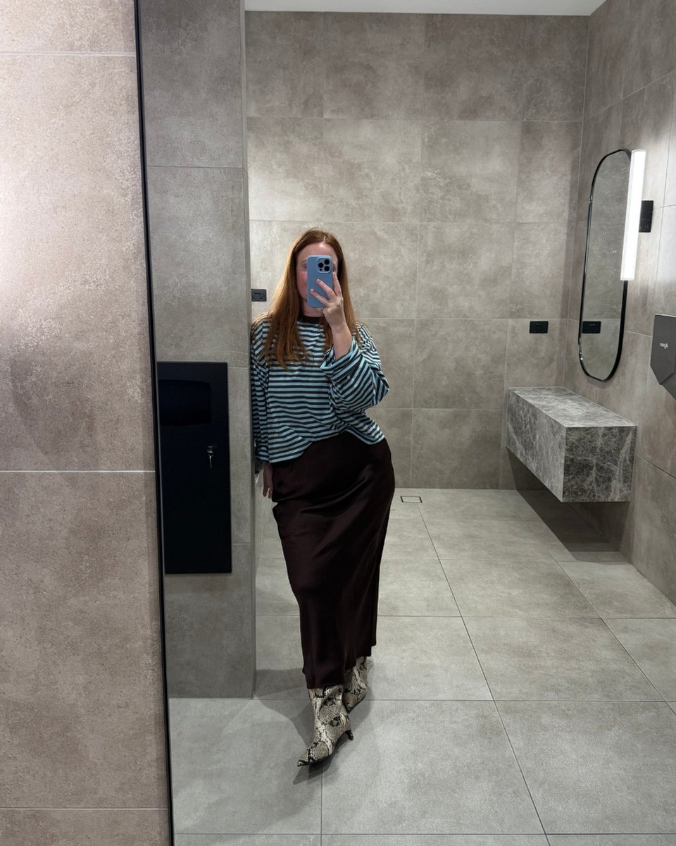 woman mirror selfie wearing lioness stripe top