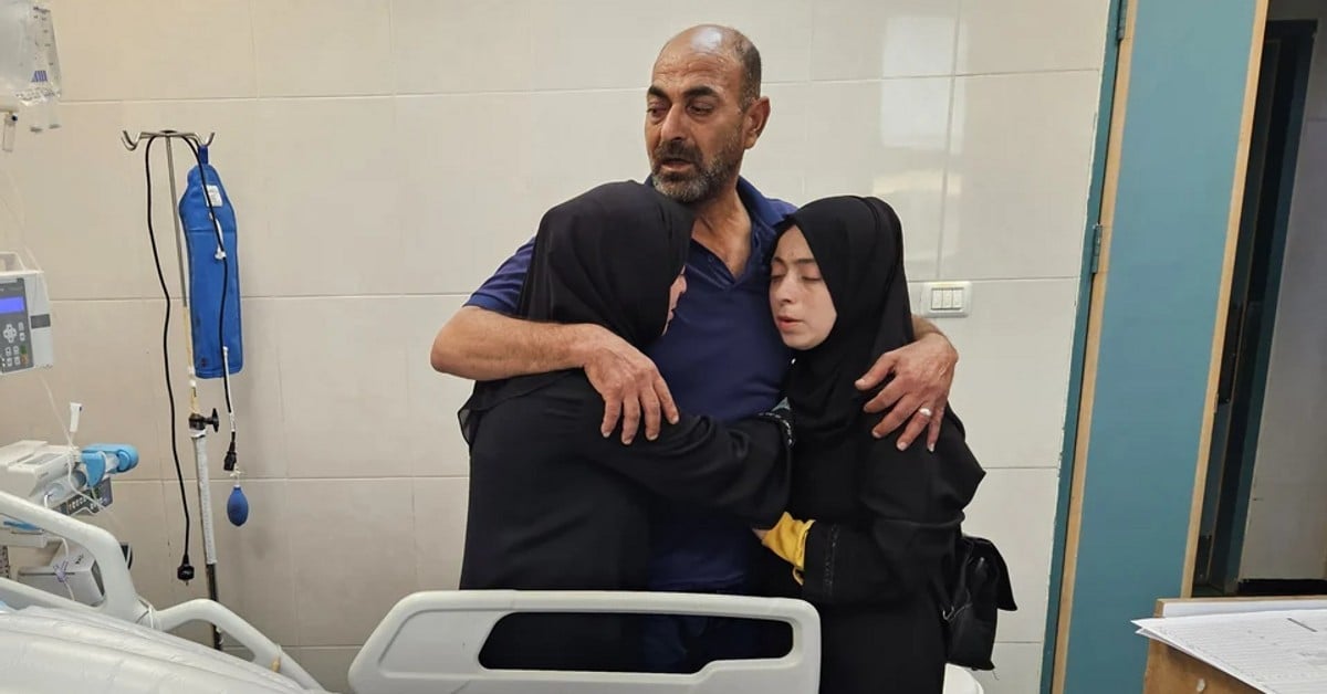 Palestinian doctor Alaa al-Najjar visits her injured husband in the intensive care unit at Nasser Hospital. 