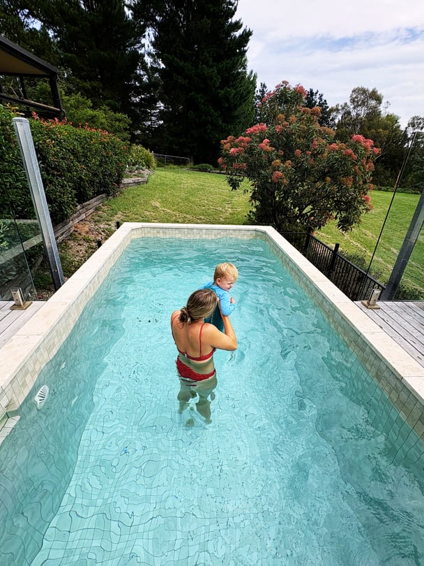 Zoe with her kid having fun in the private pool at The Lodge at Mount Kanimbla Retreats.