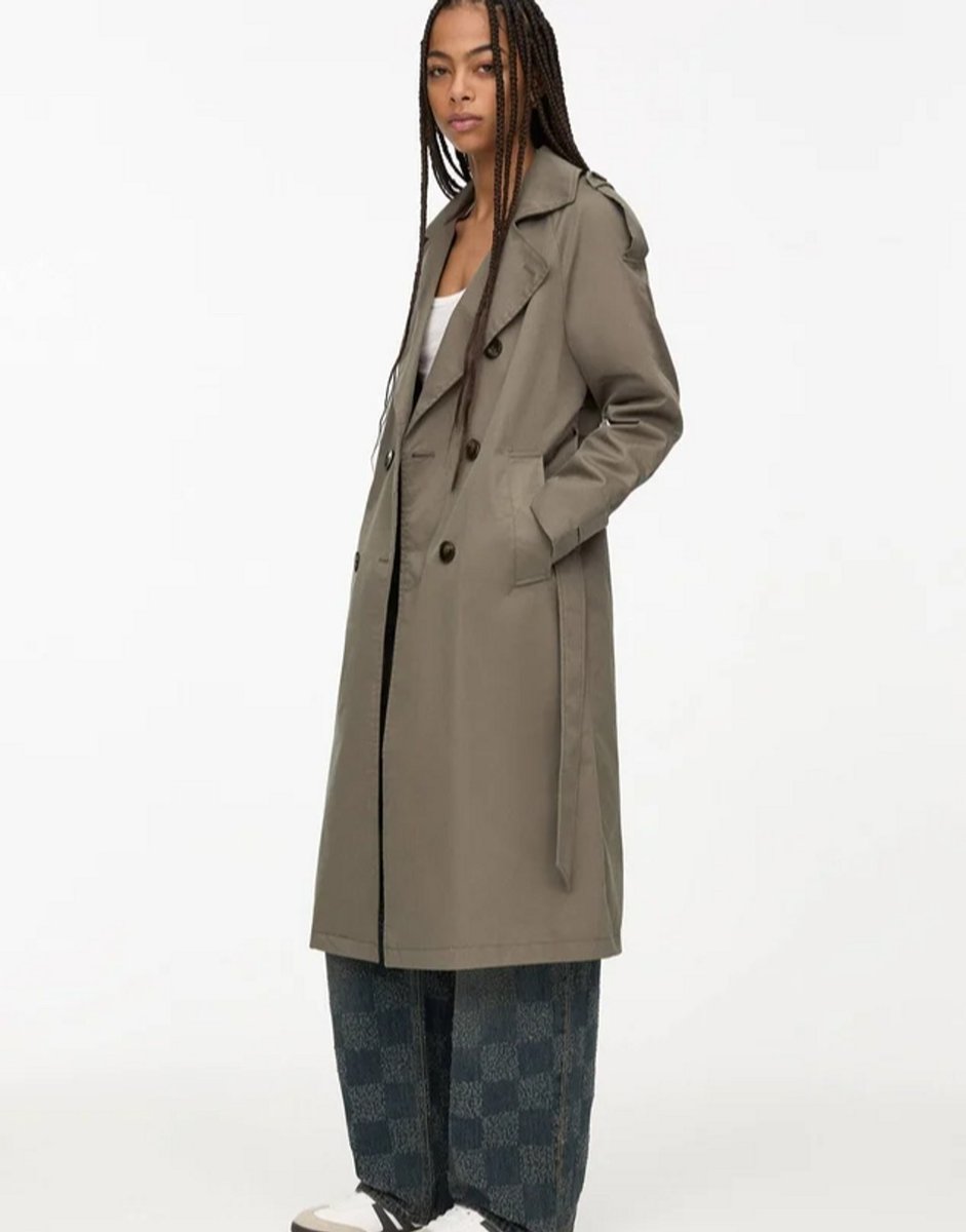 womannwearing a grey trench coat 