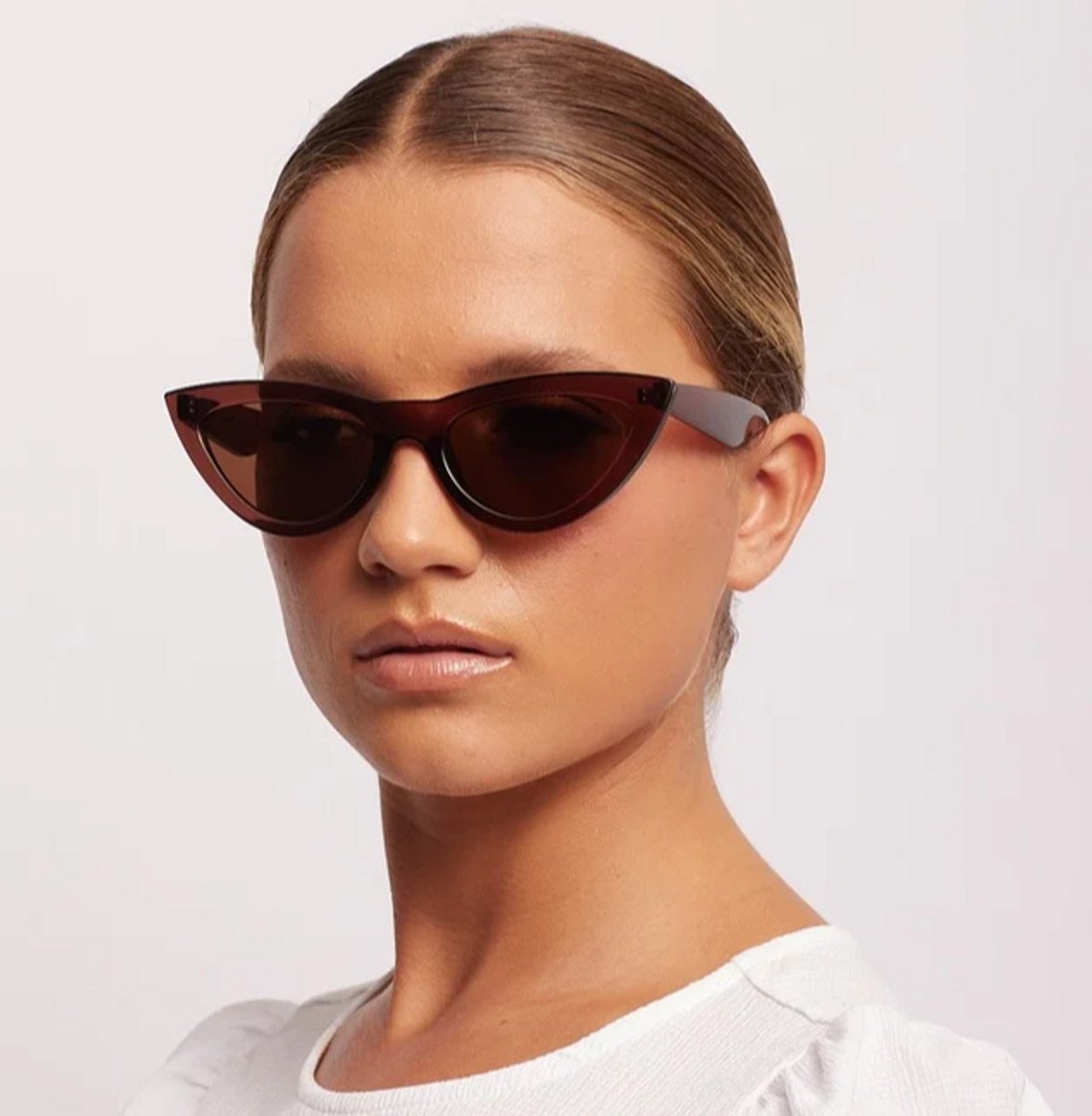 woman wearing taupe cat eye sunglasses