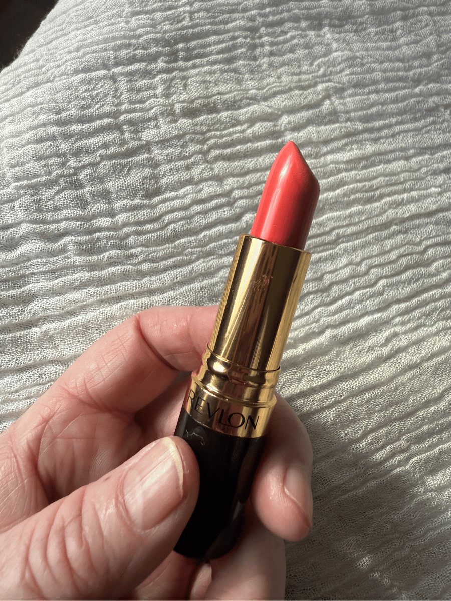 Revlon Super Lustrous lipstick in bright orange shade.