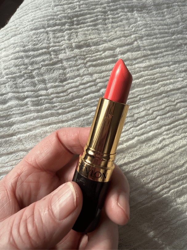 Revlon Super Lustrous lipstick in bright orange shade.