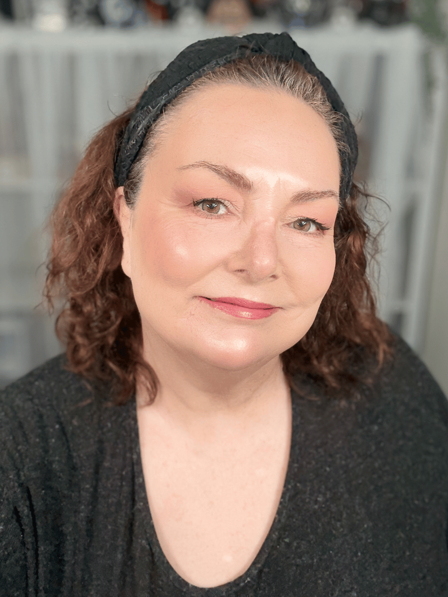 Teresa smiling wearing Revlon Super Lustrous Lipstick in Peach.
