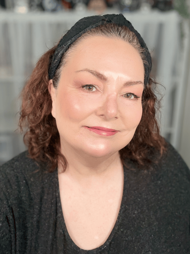 Teresa smiling wearing Revlon Super Lustrous Lipstick in Peach.