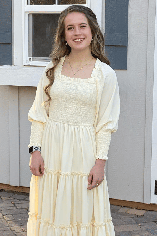 Shari Franke poses for a photo in a yellow dress.