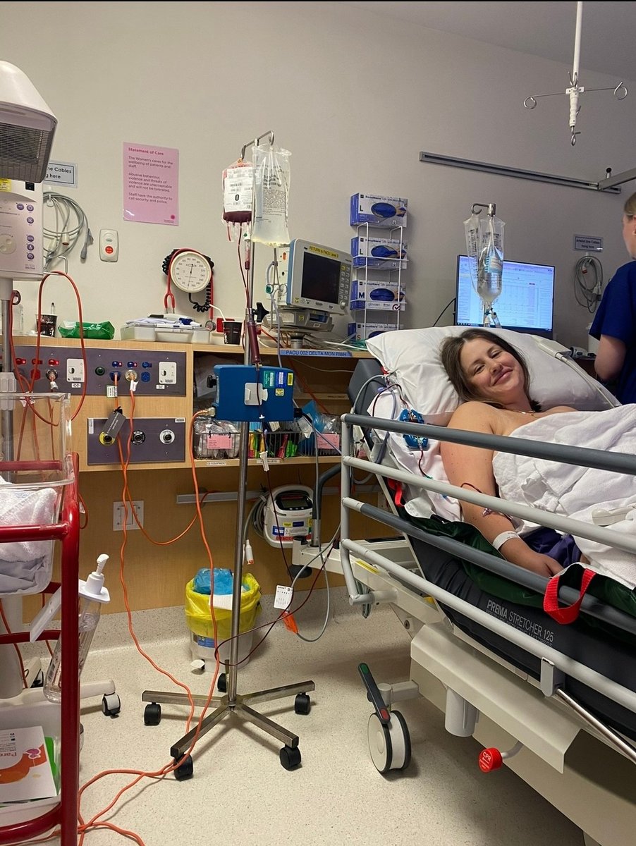Sabrina in a hospital bed after suffering a placental abruption and undergoing emergency surgery.