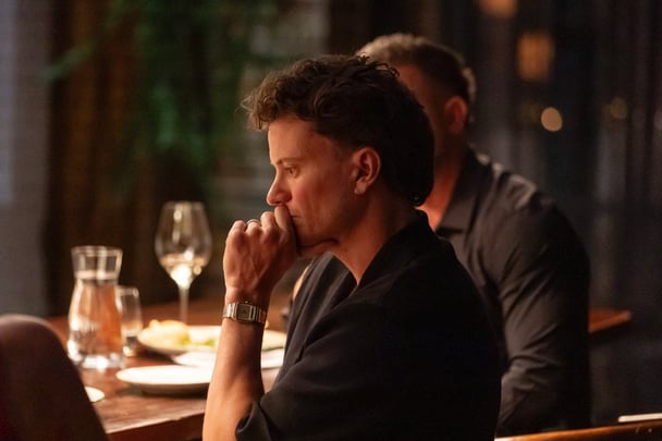 Sam looks upset at the dinner table.