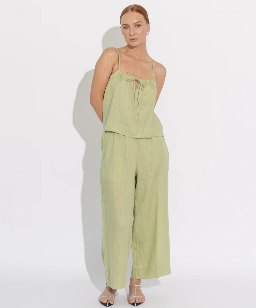 woman wearing green cami and pants 