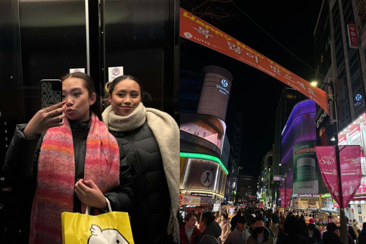 Two girls with shopping. Busy shopping street.
