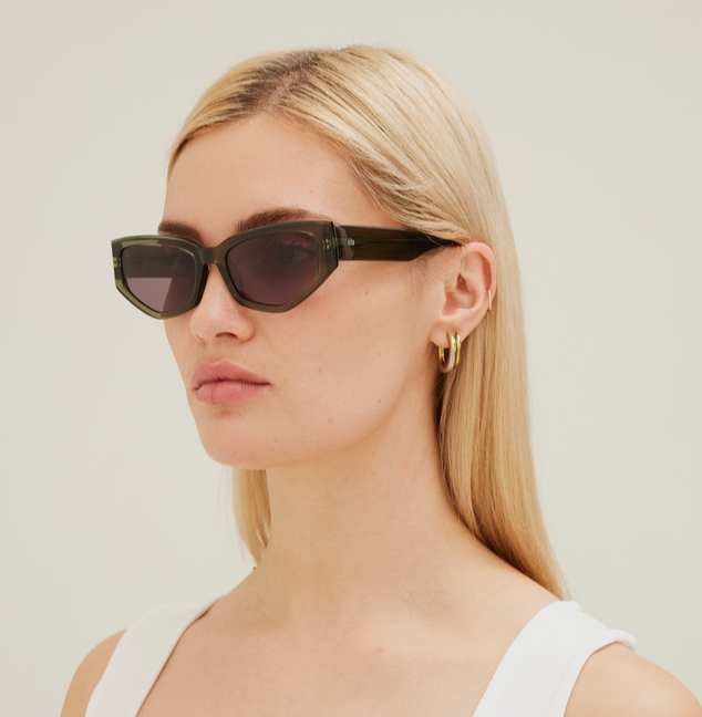 woman wearing green tilted sunglasses