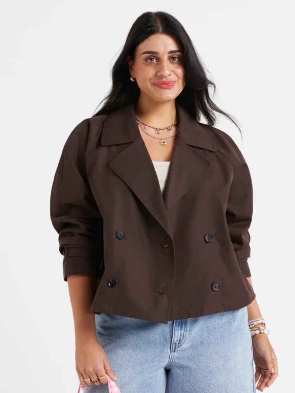 Model in cropped brown trench.