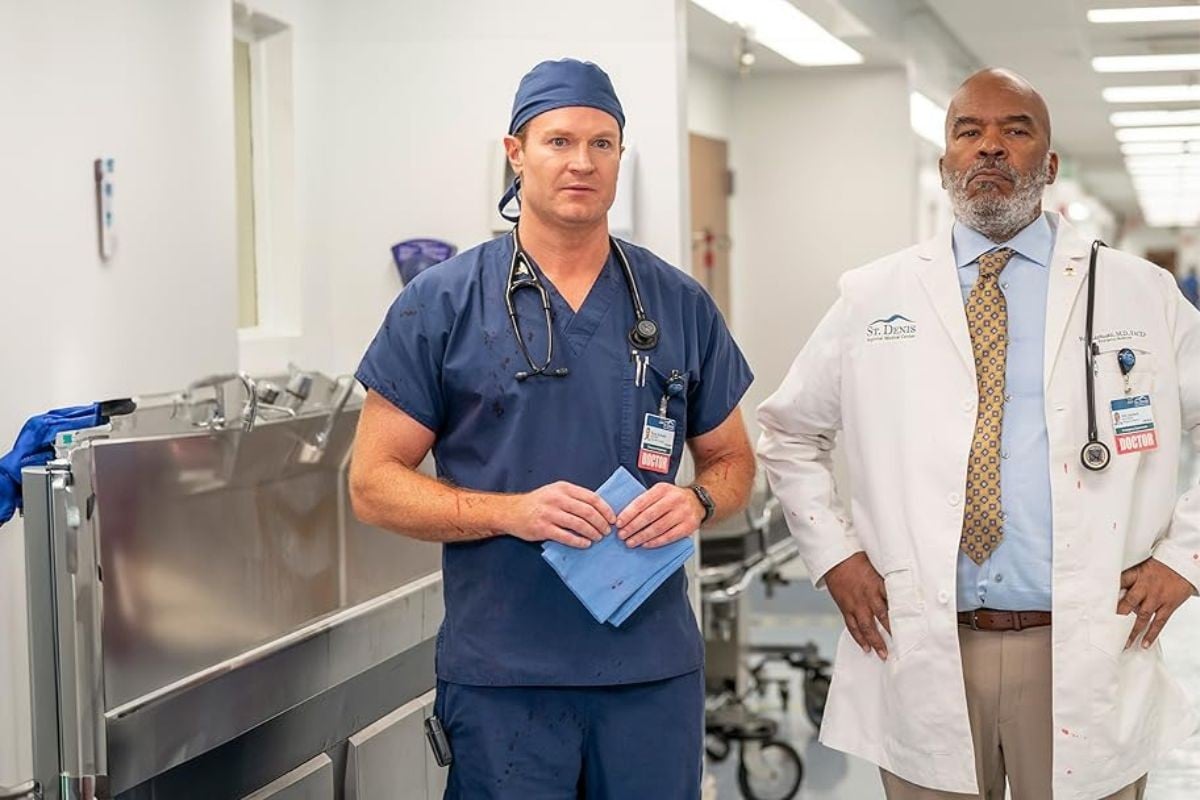 Josh Lawson and David Alan Grier in medical scrubs and outfits filming St. Denis Medica