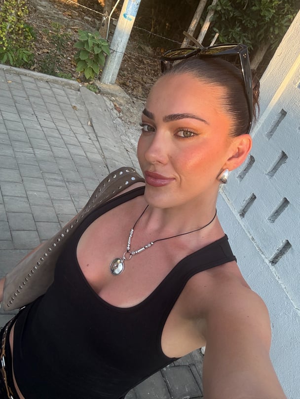 Selfie of Summer in black singlet and silver necklace.