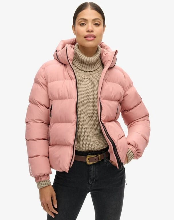 womanwearing pink puffer jacket from Superdry
