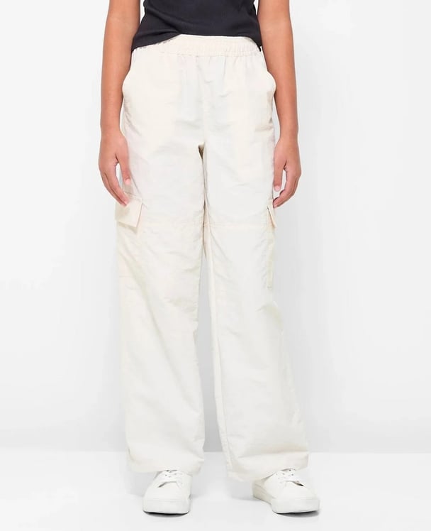 woman wearing white parachute pants