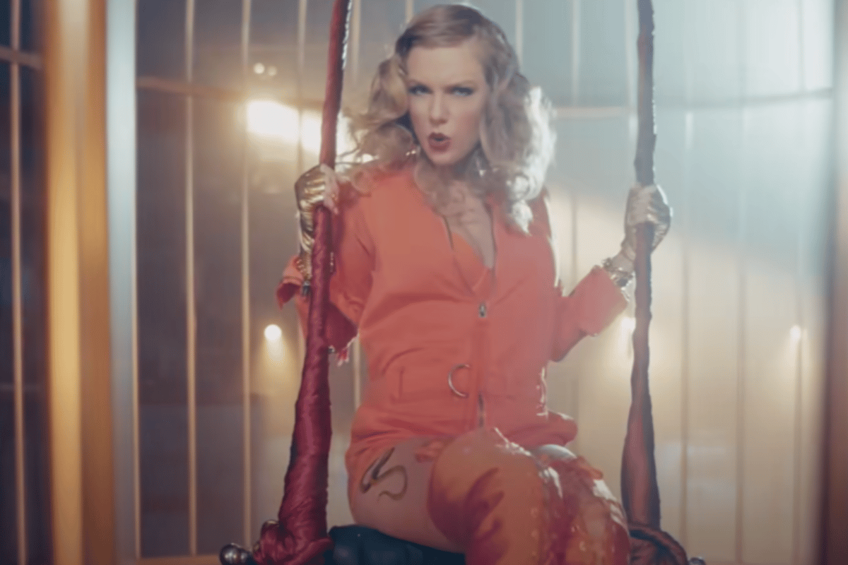 Taylor Swift in an orange jumpsuit in a birdcage in the Look What You Made Me Do (LWYMMD) video clip.