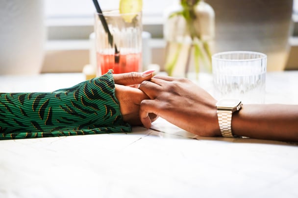 An image of two people holding hands.
