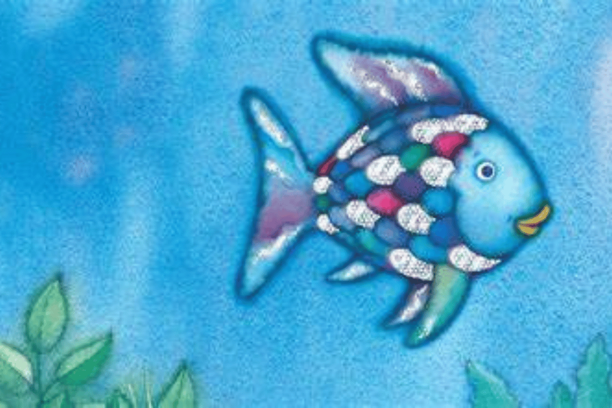 An image of the Rainbow Fish from the children's tale. He has multicoloured scales and some glittery silver ones.