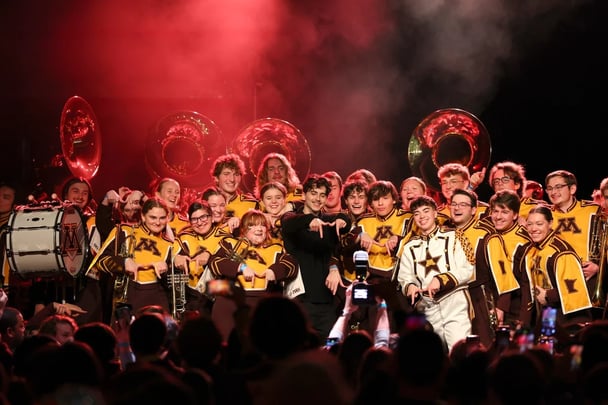 Timothée surprises the University of Minnesota marching band.