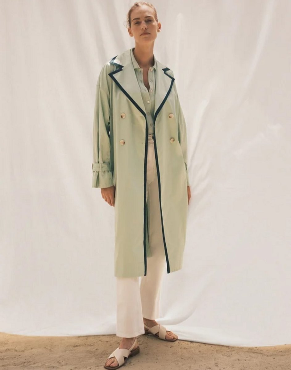 woman wearing a fern trench coat with trim