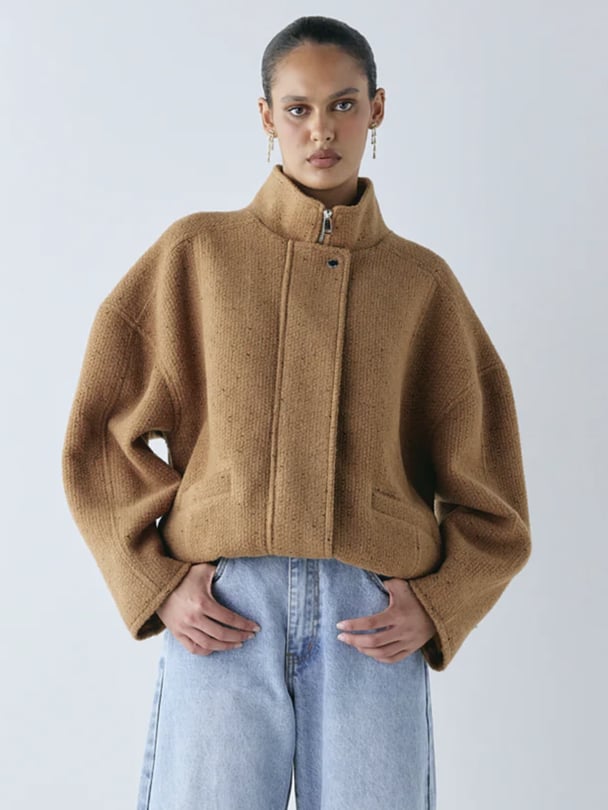 Model in cropped brown wool bomber.
