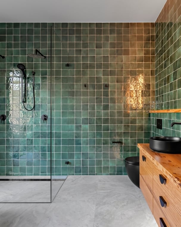 bathroom design with green tiles and matt black handles