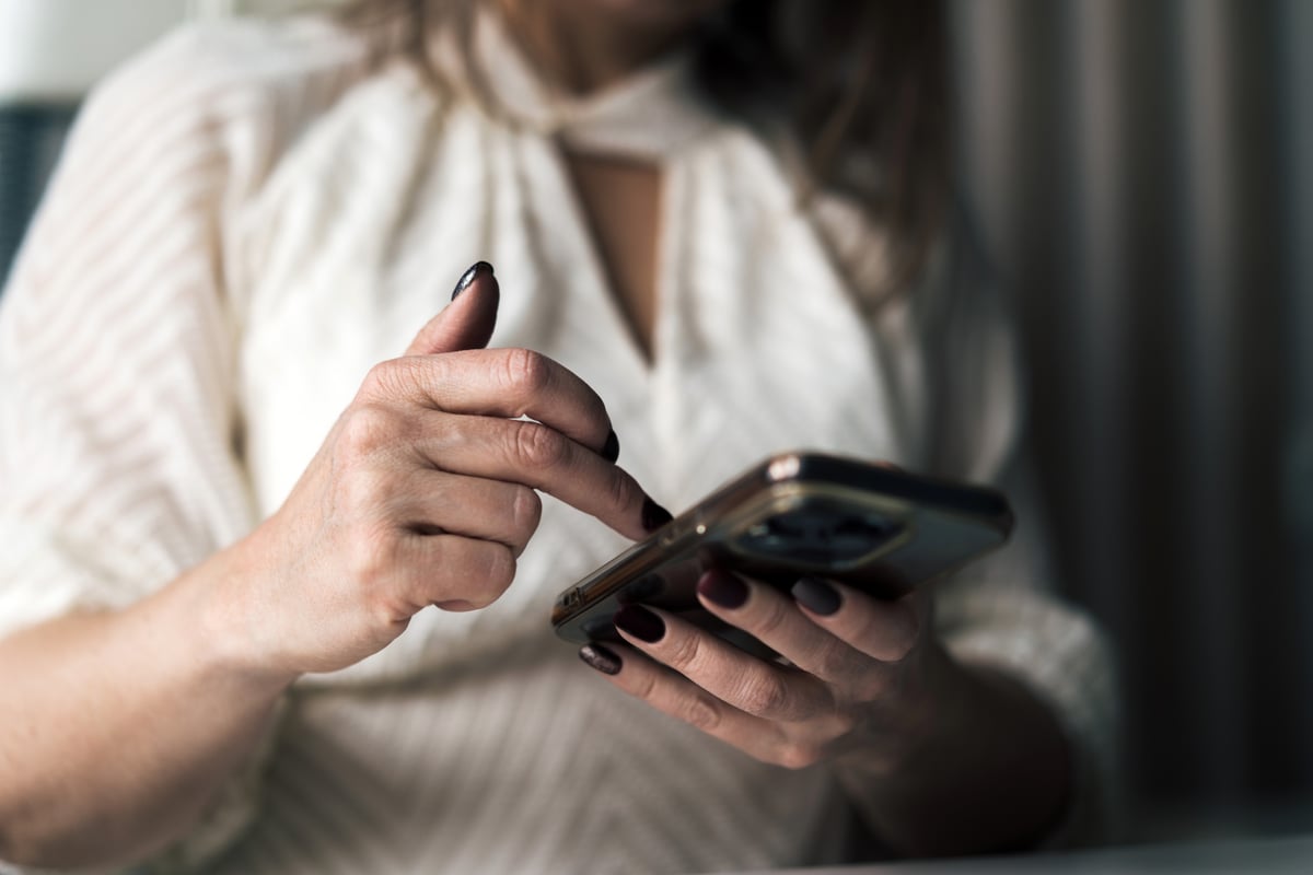 Faceless woman sending a text.