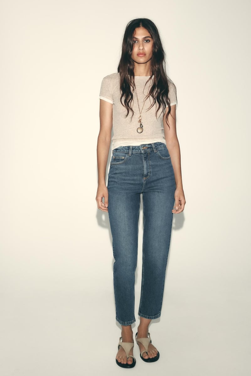 woman wearing high rise mom fit jeans 