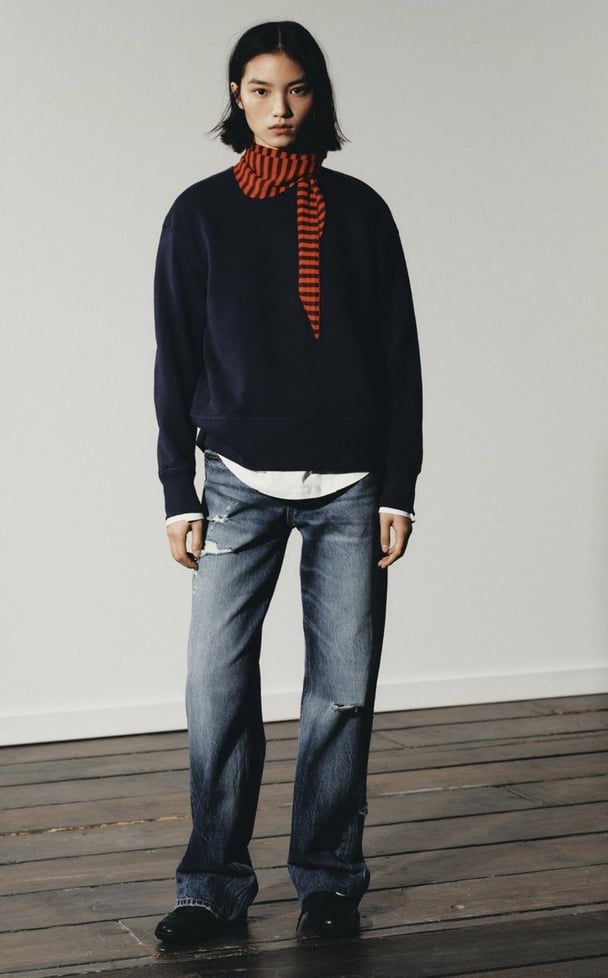woman wearing distressed jeans from Zara