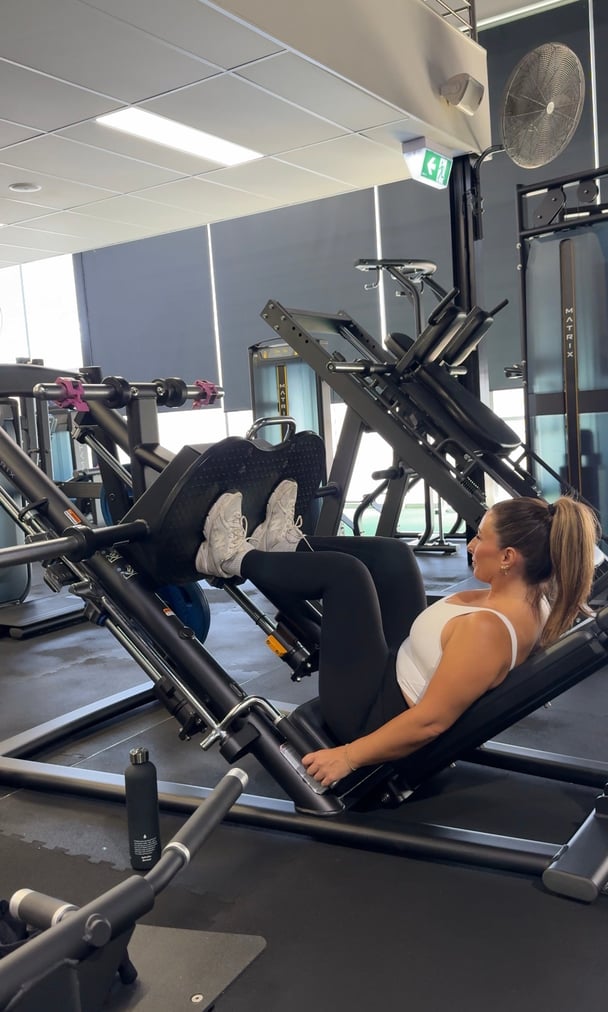 A captured moment of Zoe George mid-workout at Fernwood Fitness, focusing on her strength training routine.
