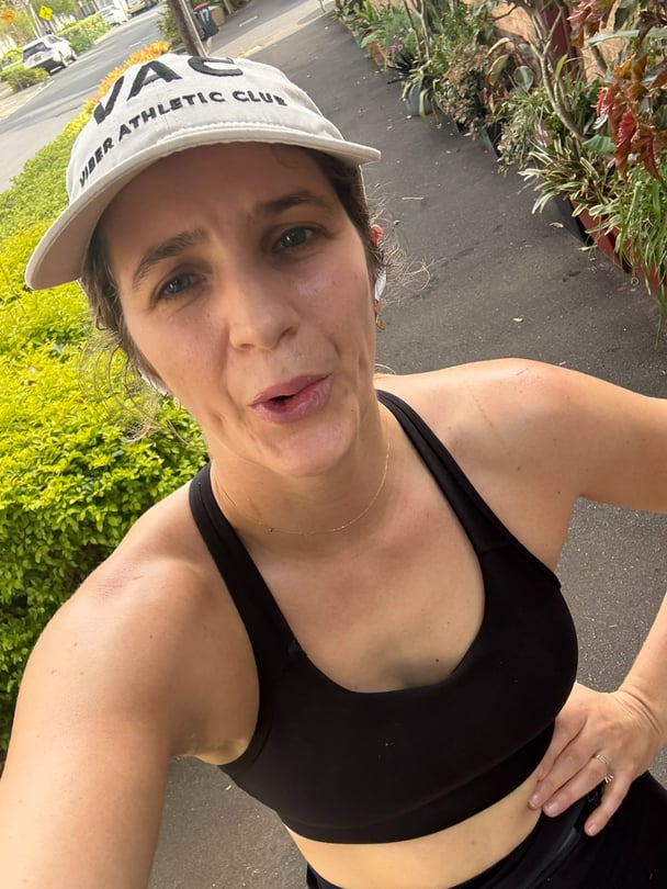 Selfie of Zoe puffing in active wear.